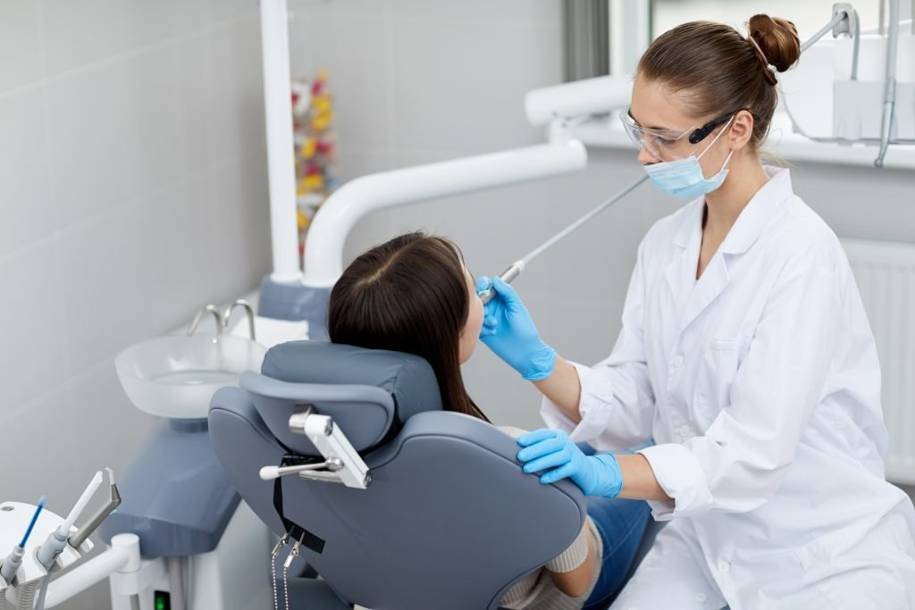 BDS Dentist with patient